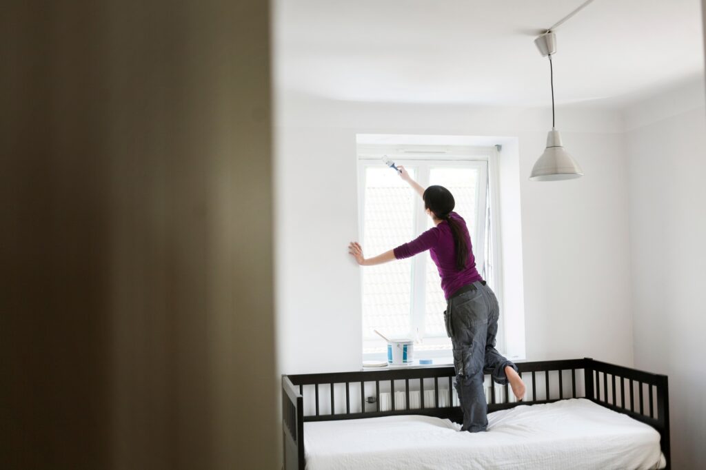 The current image has no alternative text. The file name is: woman-painting-window.jpg