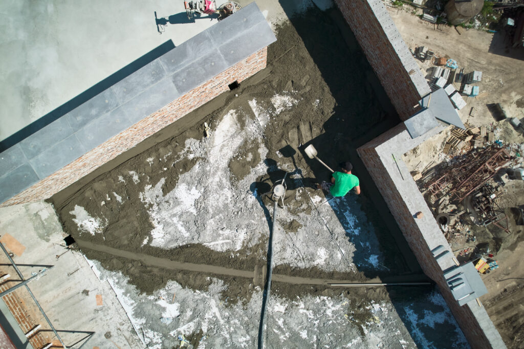 The current image has no alternative text. The file name is: aerial-view-of-man-builder-shoveling-sand-cement-m-2026-01-07-01-02-48-utc-scaled.jpg